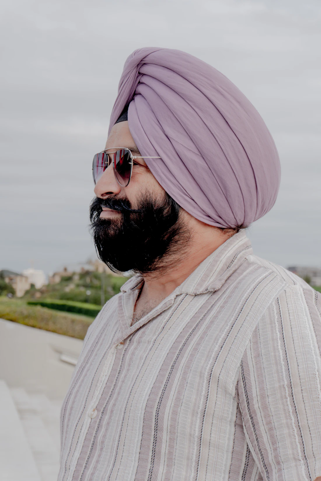 Man in a lilac turban wearing aviator sunglasses