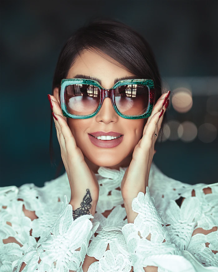 Smiling woman in green oversized sunglasses