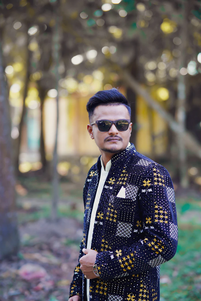 Man in a printed jacket wearing dark sunglasses
