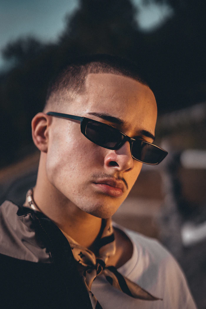 Man in a black shirt wearing narrow sunglasses
