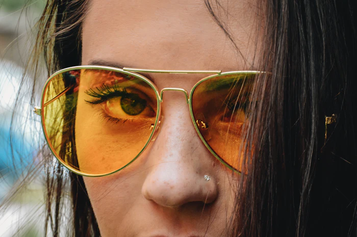 Close-up of woman in gold aviators with amber lenses